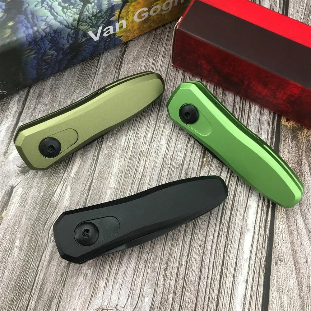 Three folding pocket knives in olive green, bright green, and black are displayed on a wooden surface next to a box.