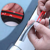 Hands are installing a black rubber seal strip with red wires onto a car window frame.