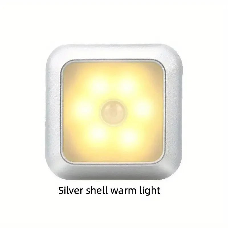 Silver shell automatic motion sensor night light with a warm yellow light.