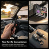 A hand holds a black remote key for a universal garage door opener replacement, shown in a vehicle interior context.