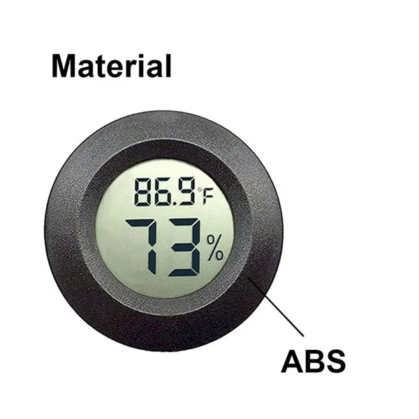 A round, black plastic device labeled ABS displaying a temperature of 86.9°F and 73% humidity.
