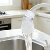 A reusable white cotton filter is shown dispensing clean water from a kitchen faucet.