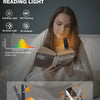 A woman is reading a book using an amber mode eye protection light, demonstrating its features and angle.