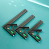 A set of precision measuring tools, including a ruler and holders, displayed on a teal surface.