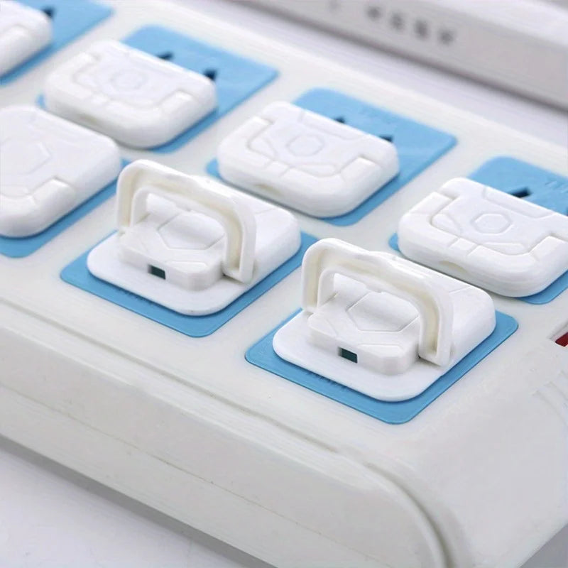 A collection of white and light blue outlet covers for baby proofing, arranged in a plastic holder.