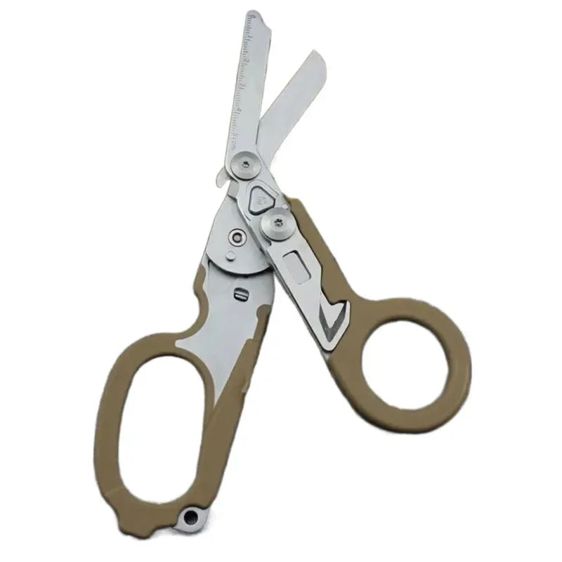 A pair of tactical foldable shears with silver and tan handles shown against a white background.