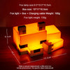 A glowing orange fox night light lamp with a box design and charging cable shown on a wooden surface.