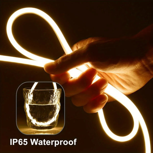 A hand is holding a glowing white neon strip light, demonstrating its IP65 waterproof feature.