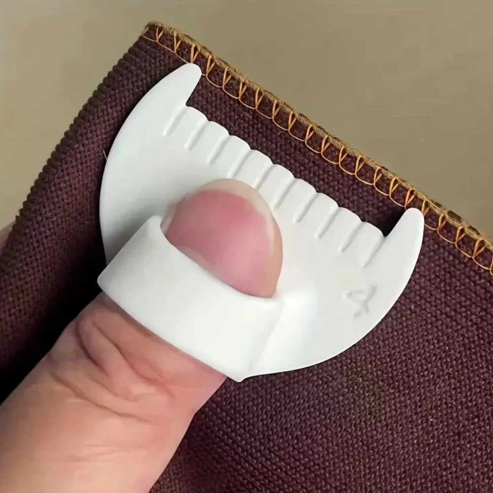 A hand holding a white plastic sewing stencil kit against a dark brown fabric background.