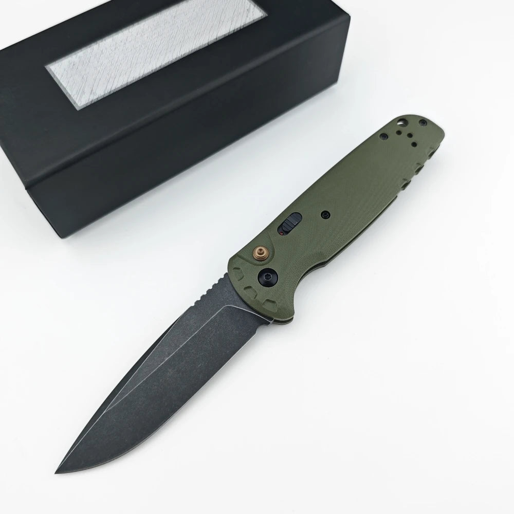 A folding utility knife with a green handle and black sheath is shown on a white background.