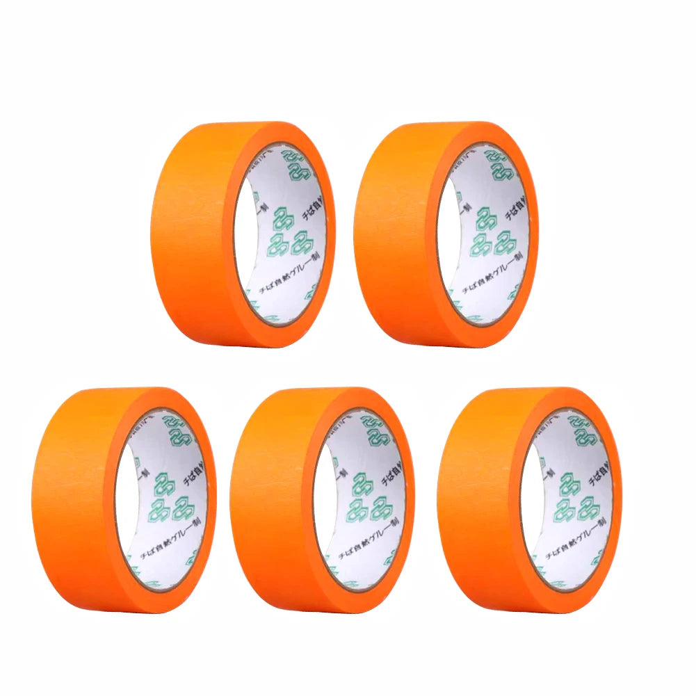 Four orange rolls of professional painter's masking tape applicator shown from the side.