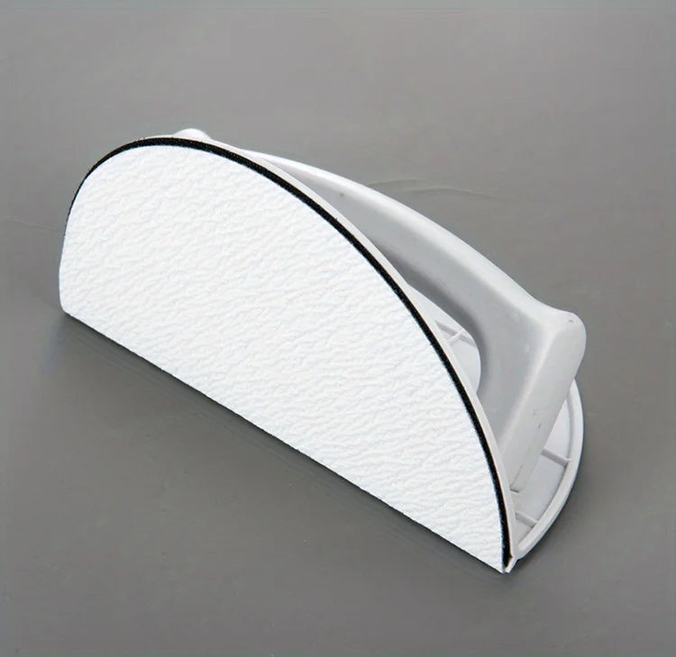 A white self-adhesive half circle sanding pad holder with a black trim, shown in a profile view.