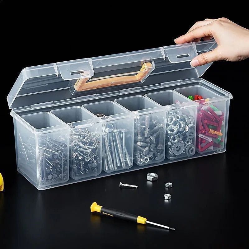 A clear multi-compartment tool organizer box set with various metal tools and hardware inside, being held by a hand.