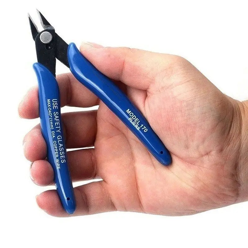 A hand holds a blue universal diagonal pliers with black handles, used for wire and cable cutting.
