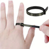 A black accurate finger ring sizer is shown being used to measure a finger, with a scale visible on the device.
