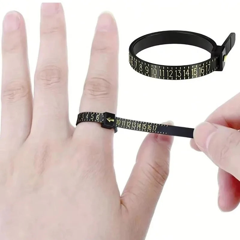 A black accurate finger ring sizer is shown being used to measure a finger, with a scale visible on the device.