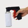 A hand holds a black spray paint handle with a red grip and a silver bottle for DIY use.