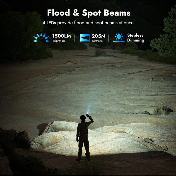 A person is using a flood and spot beam from a 4 LED flashlight in an outdoor, rocky environment.