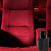 A close-up of a red upholstered chair with a black cup holder rack on the seat.