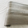 Roll of thickened wood grain self-adhesive wall decals in a muted gray tone.