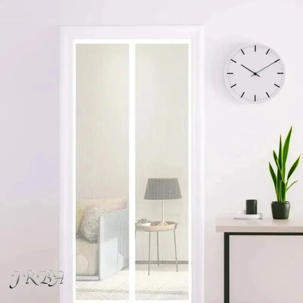 A white framed mirror reflects a room interior, with a black clock and a potted plant visible on the wall.