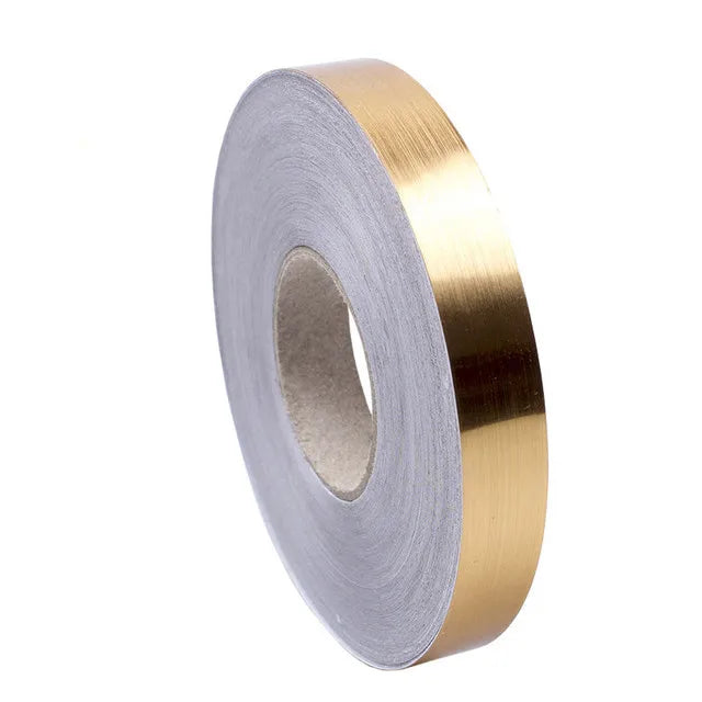 Roll of gold-colored self-adhesive decorative tile gap tape for sealing joints