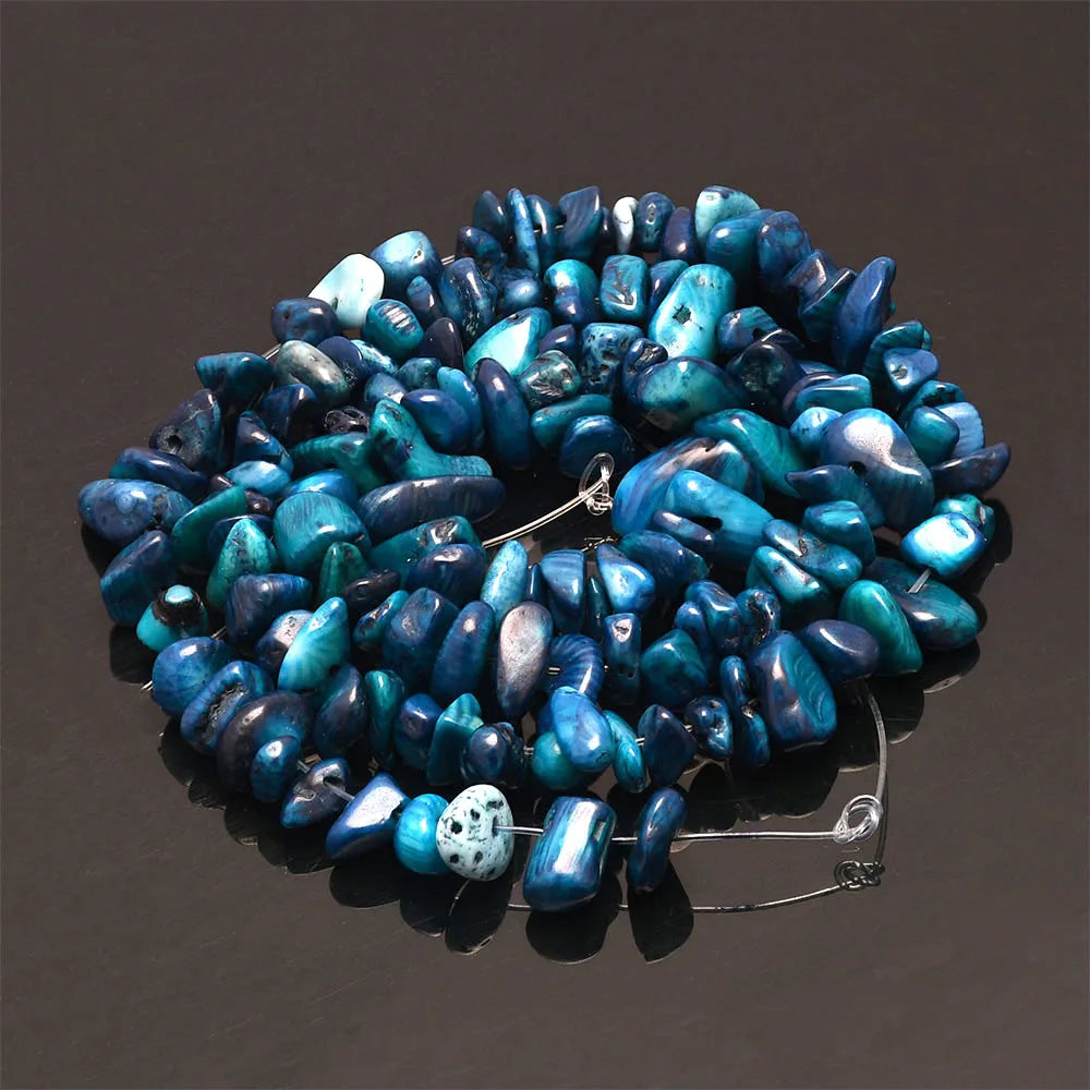 A circular arrangement of vibrant blue and turquoise natural agate beads for DIY jewelry making.