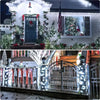 Outdoor LED string lights decorating a front door and window with festive greenery and lights.