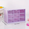 A purple acrylic drawer organizer with nine compartments is shown on a white surface.