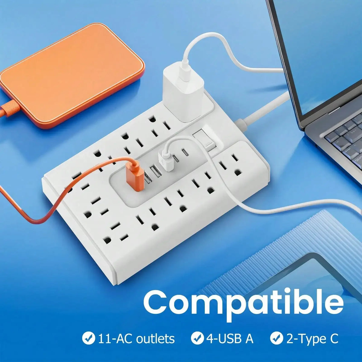 White multi-port power strip with 11 AC outlets, 4 USB A ports, and 2 Type C ports shown next to a laptop and an orange devic