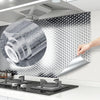 A hand is peeling a sheet of silver aluminum foil from a roll, demonstrating self-adhesive contact sheets for kitchen and hom
