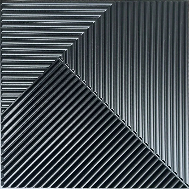 A close-up view of black, ribbed 3D diamond PVC wall panels arranged in a sharp diagonal pattern.
