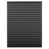 Close-up view of black pleated window blinds.