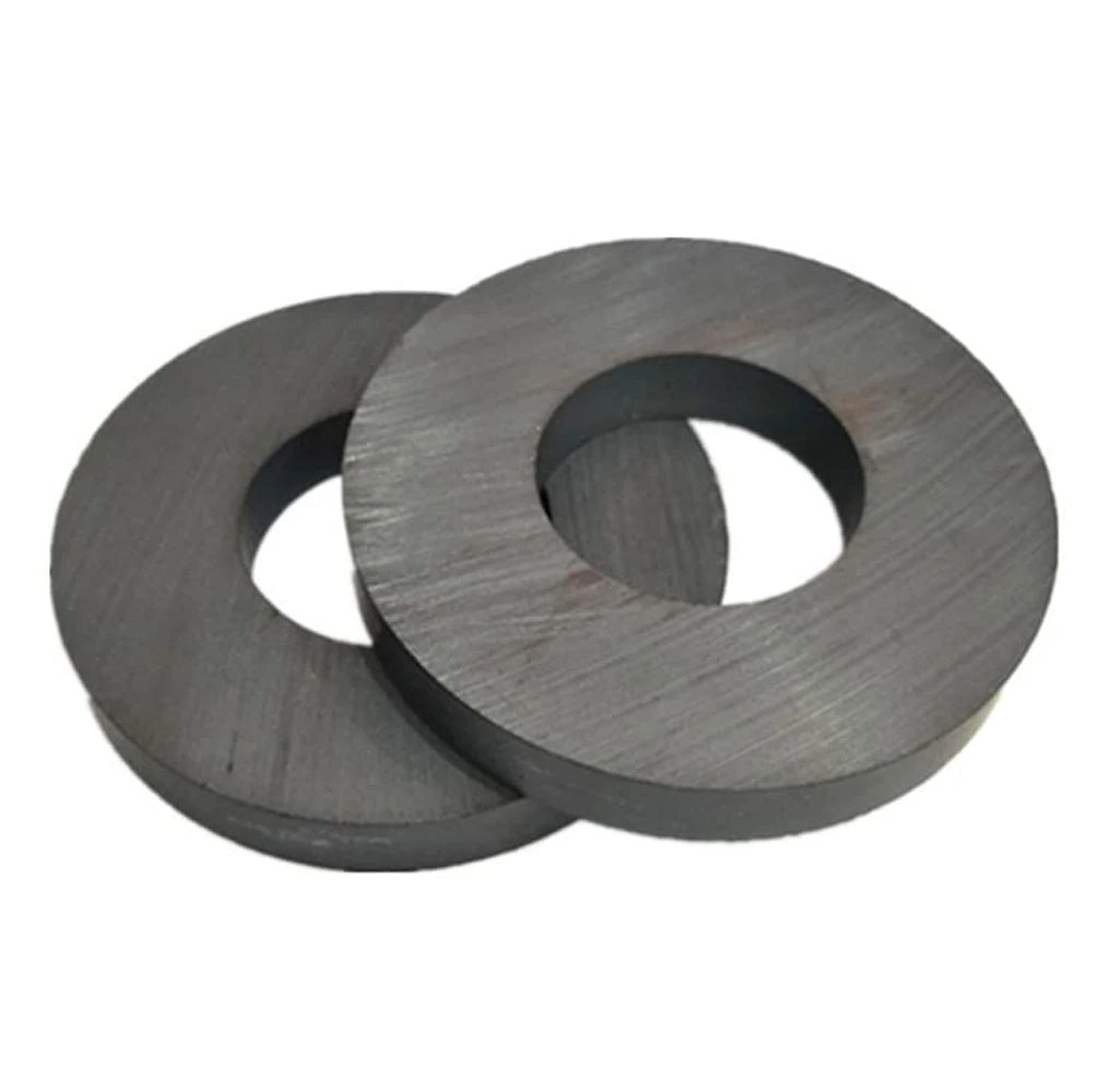 A set of two industrial ceramic ring magnets with a dark gray finish.