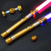 A golden lightsaber with a glowing pink and blue blade is shown against a dark background.