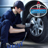 A man in a dark blue uniform is using a tool to attach a neon sign to a car tire.