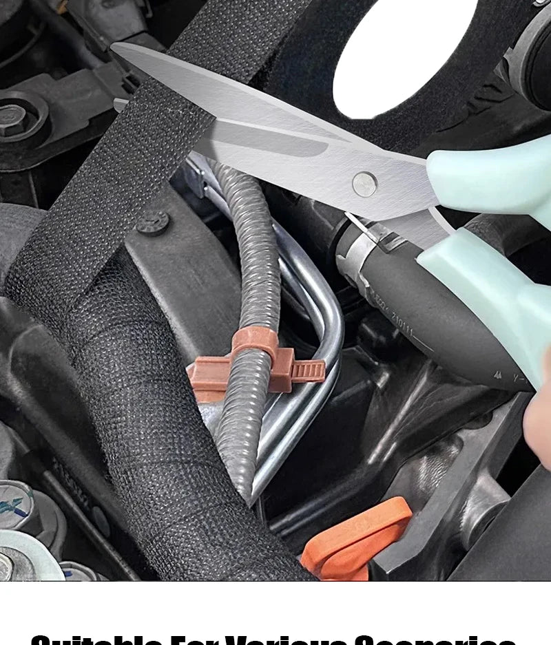A pair of silver-bladed pliers is shown gripping a black electrical wire harness in an automotive engine bay setting.