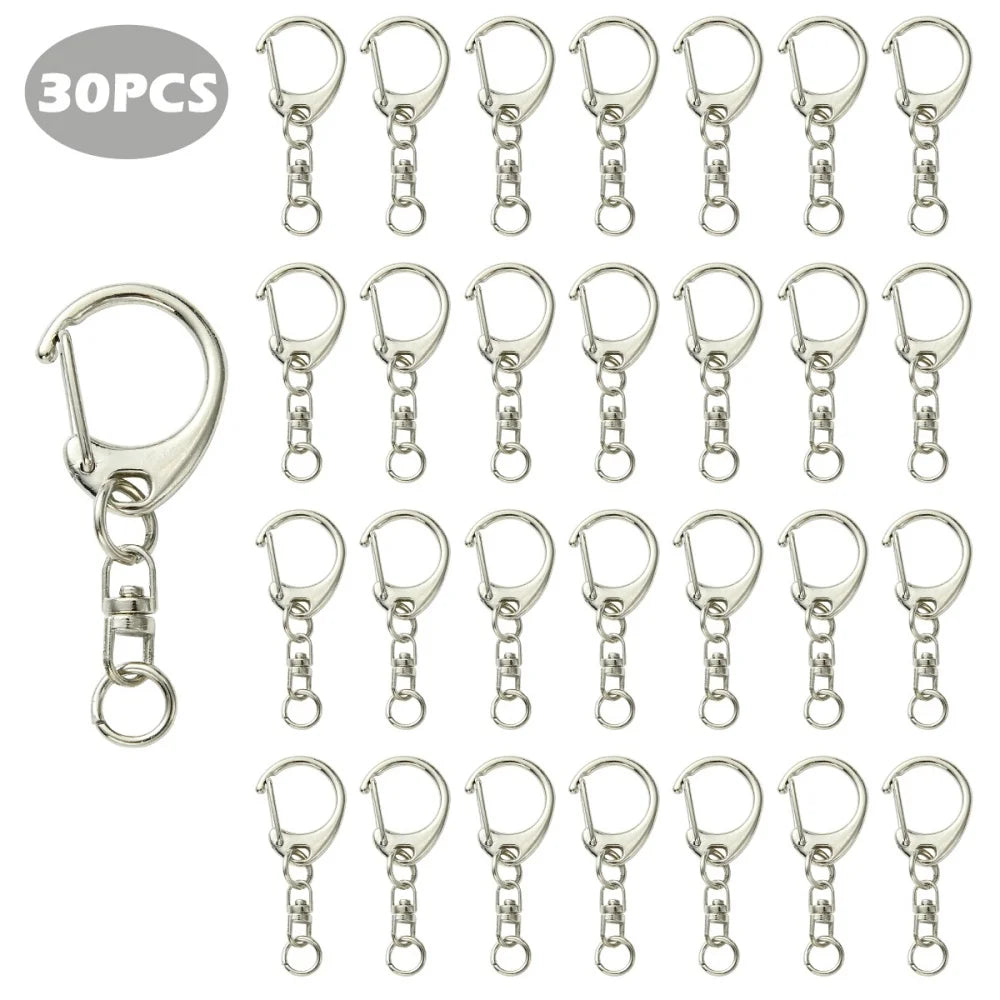 A collection of 30 pieces of silver-toned lobster clasp key rings and charms.