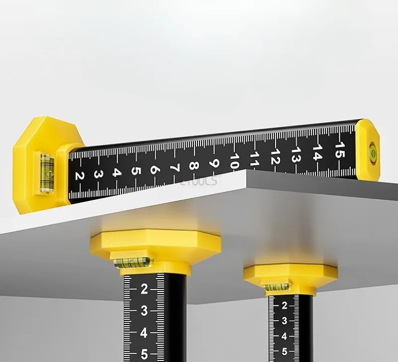 A precision ceiling leveling tool with a black ruler and yellow mounting brackets is shown against a white background.