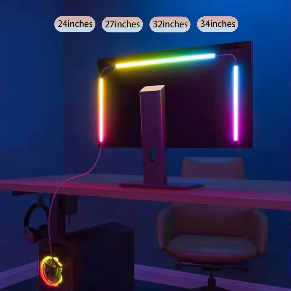 A computer monitor is illuminated by colorful RGB LED strips, with a separate device glowing in the foreground.