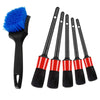 A set of six detailing brushes, including a blue bristled brush and five black and red cleaning brushes.
