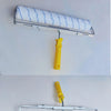 Set of heavy-duty paint roller brushes with a white and blue foam roller and yellow handle on a metal holder.