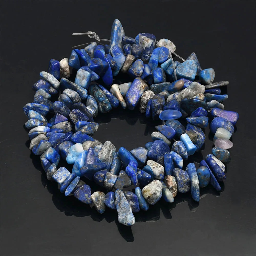 A circular arrangement of tumbled blue and gray agate beads used for DIY jewelry making.
