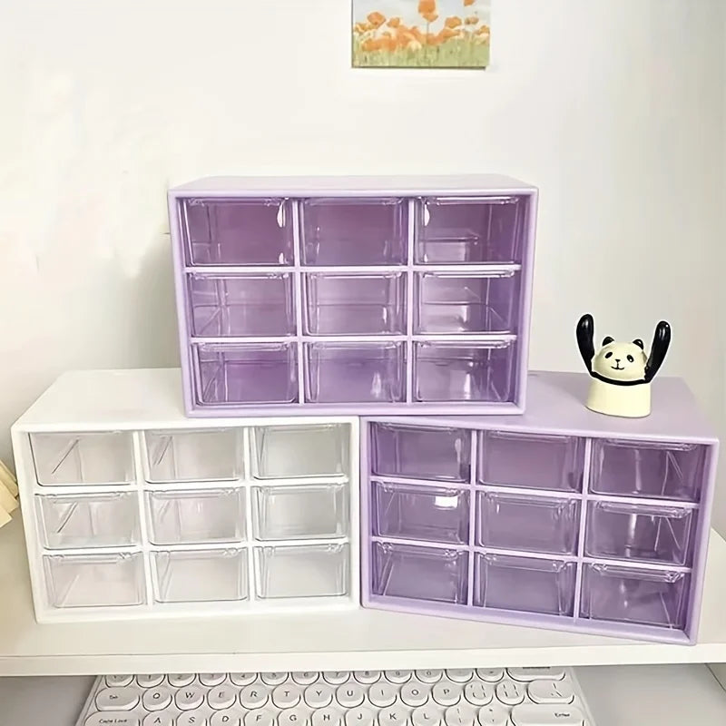 A purple acrylic drawer organizer with multiple compartments is displayed on a white shelf.