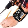 A hand holds a magnetic wrist strap tool with various screws and rods attached for DIY and repair.