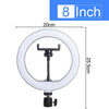 Una luz de anillo blanca con un trípode negro ajustable, de 20 cm de altura.