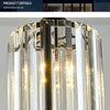 Modernes Kristall-LED-Kronleuchter mit zylindrischer Glas-Schirm und Metallakzenten.
