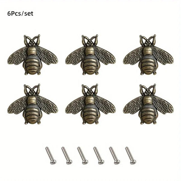 Set of six vintage bee cabinet handles or retro bar drawer pulls in antique brass finish.
