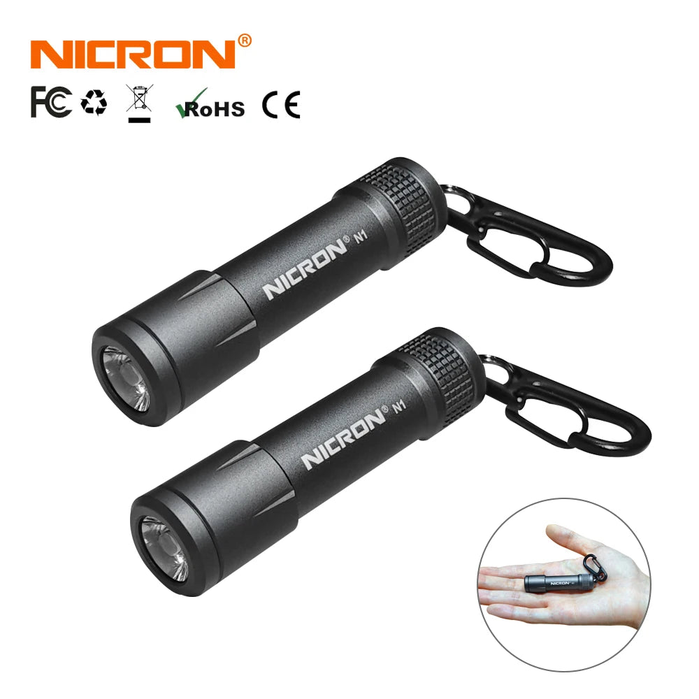 A black Nichron N1 mini key chain LED flashlight with a protective casing and clip.