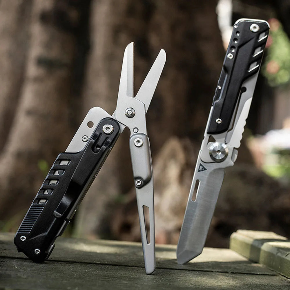 A pair of silver compact multi-tool pocket knives resting on a wooden surface.